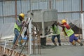 Group of construction workers concreting slab at the construction site